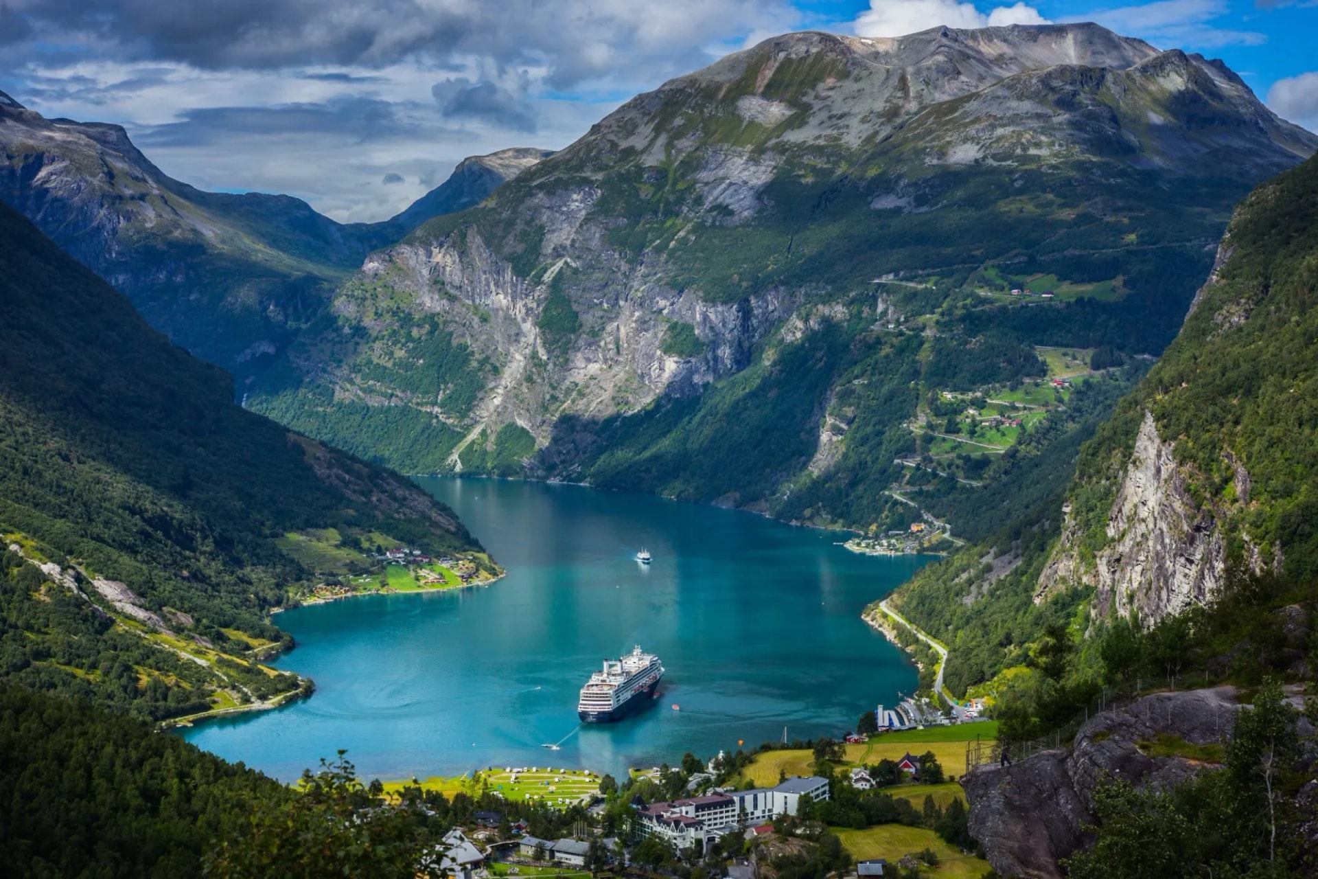 Cruise ships stand in the harbor of the Geiranger fjord, Norway